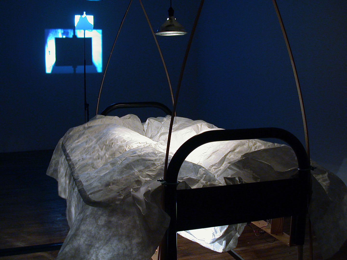 Diane Landry, The Magic Shield (detail), 2005, installation with automation, 2 futon-frame-beds, motors, selected objects, aluminum, wood, halogen lamp, MIDI controller, computer.