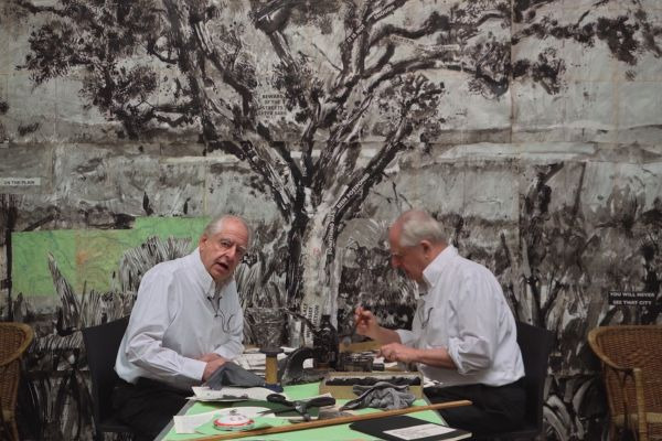 William Kentridge appears twice in the same image, while working on his studio.